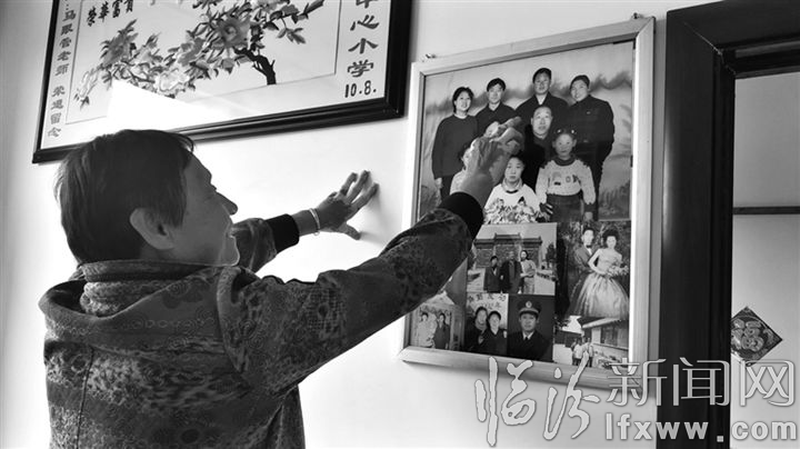 李麦香高兴地为记者介绍全家福。